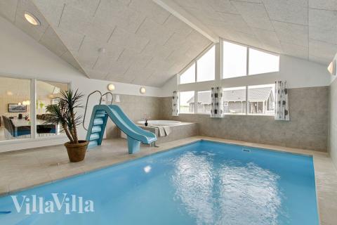 Badglada gäster kan utnyttja husets pool med vattenrutschbana och motströmsanläggning