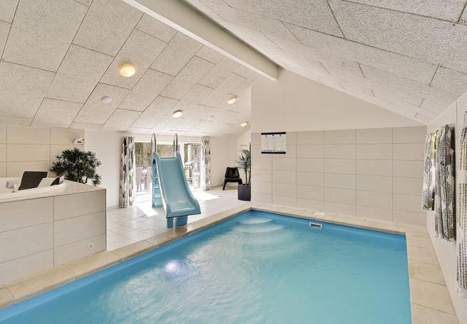 Badglada gäster kan utnyttja husets pool med vattenrutschbana och motströmsanläggning