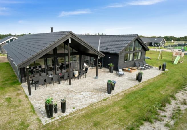 Den praktfulla poolstugan nr 464 med plats för 16 personer ligger i Vestjylland