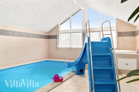 Sommarstuga 733 är inredd med en smakfull poolavdelning som har vattenrutschbana, ett stort inbyggt spapad och bastu