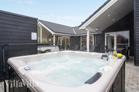 Njut av spabadets värme i lyxstuga nr 521 i Sydjylland