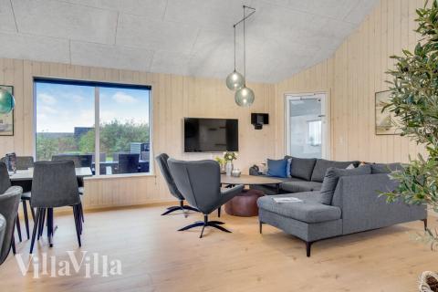 I soffhörnan i lyxstuga 529 i Nordjylland kan ni spela brädspel eller titta på film tillsammans.