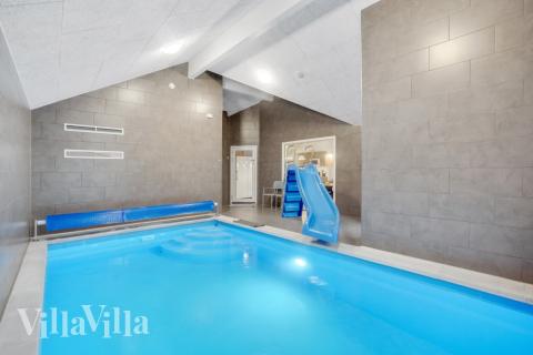 Sommarstuga 545 är inredd med en smakfull poolavdelning som har vattenrutschbana, ett stort inbyggt spapad och bastu