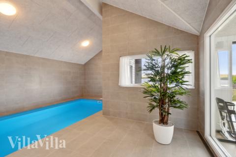 Sommarstuga 617 är inredd med en smakfull poolavdelning som har vattenrutschbana, ett stort inbyggt spapad och bastu