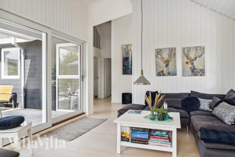 I soffhörnan i lyxstuga 691 i Nordjylland kan ni spela brädspel eller titta på film tillsammans.