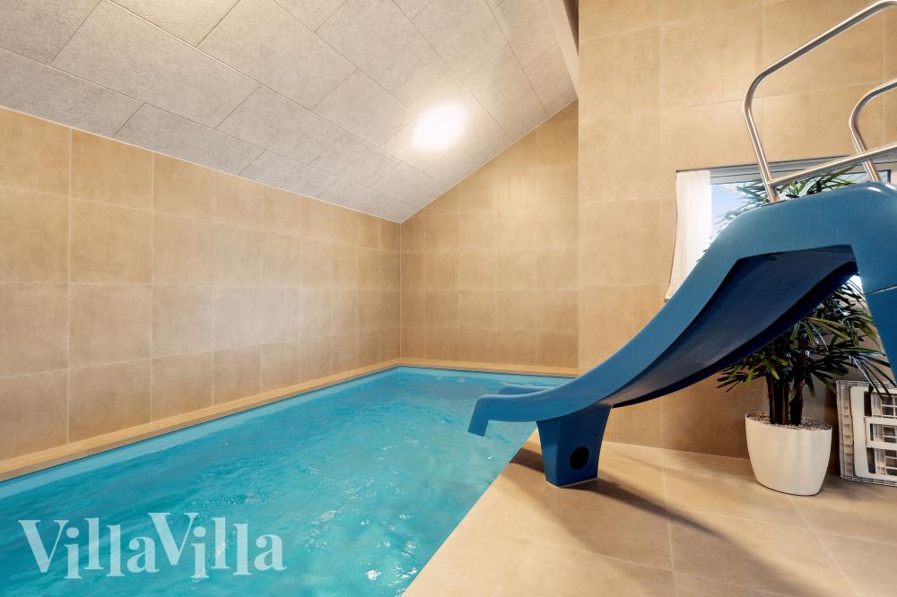 Sommarstuga 912 är inredd med en smakfull poolavdelning som har vattenrutschbana, ett stort inbyggt spapad och bastu