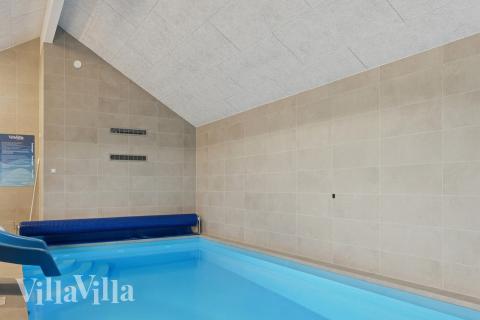 Sommarstuga 902 är inredd med en smakfull poolavdelning som har vattenrutschbana, ett stort inbyggt spapad och bastu