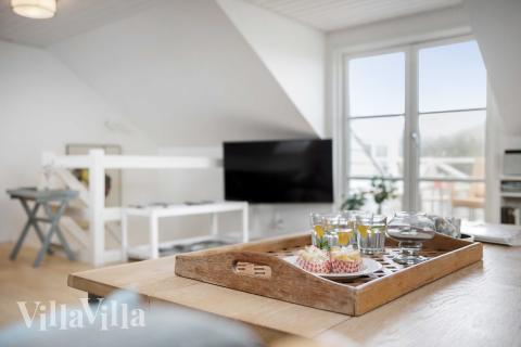 I soffhörnan i lyxstuga 953 i Vestjylland kan ni spela brädspel eller titta på film tillsammans.