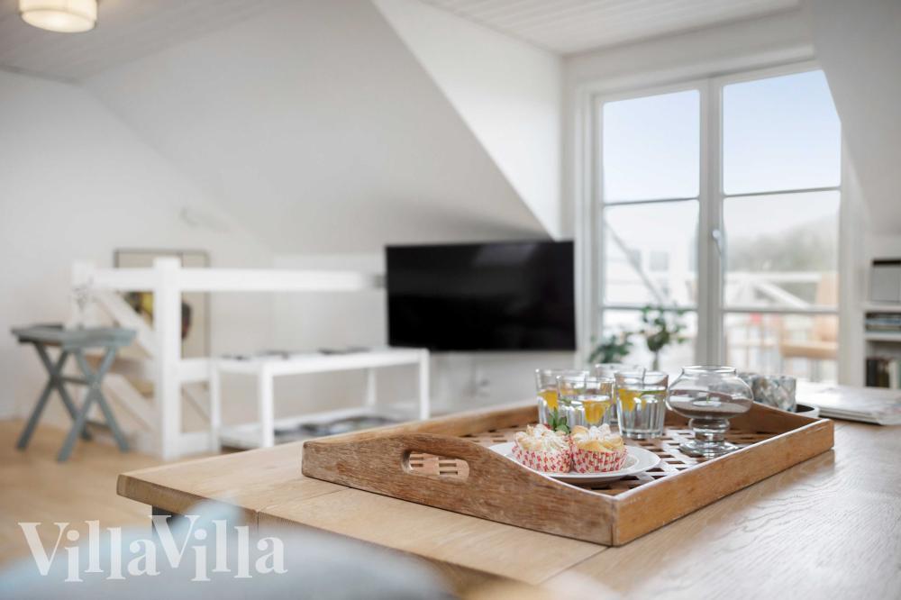 I soffhörnan i lyxstuga 953 i Vestjylland kan ni spela brädspel eller titta på film tillsammans.