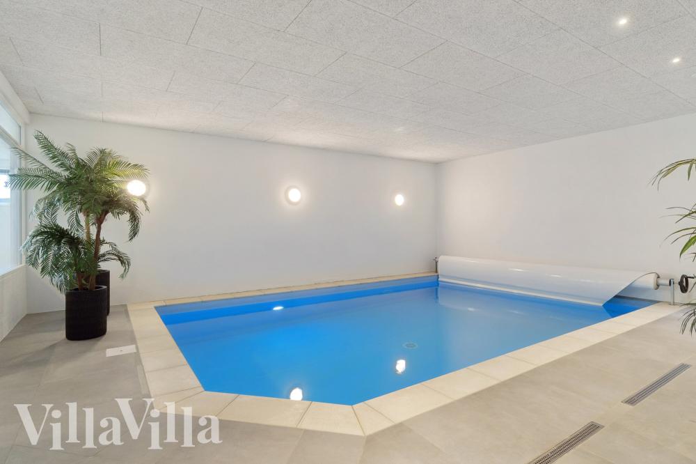 Sommarstuga 1022 är inredd med en smakfull poolavdelning som har vattenrutschbana, ett stort inbyggt spapad och bastu